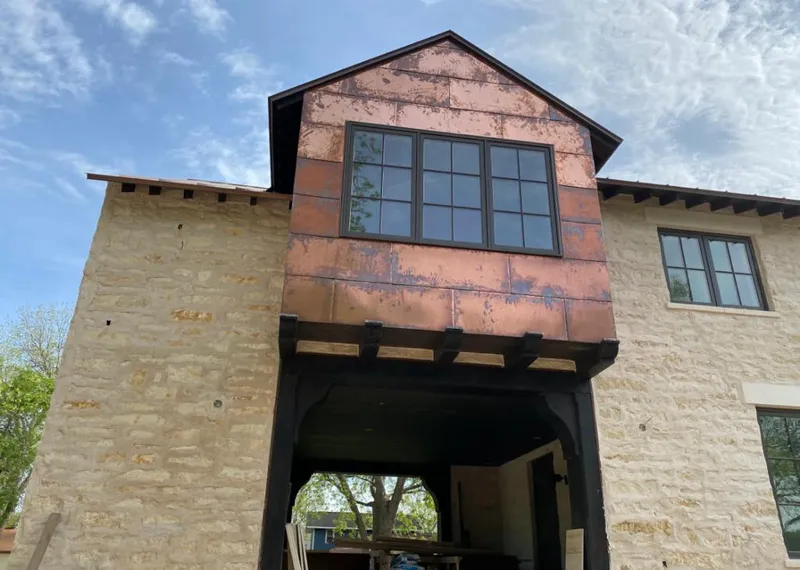 Copper metal panel facade on a stone building for Skylight Installation in Greenwood